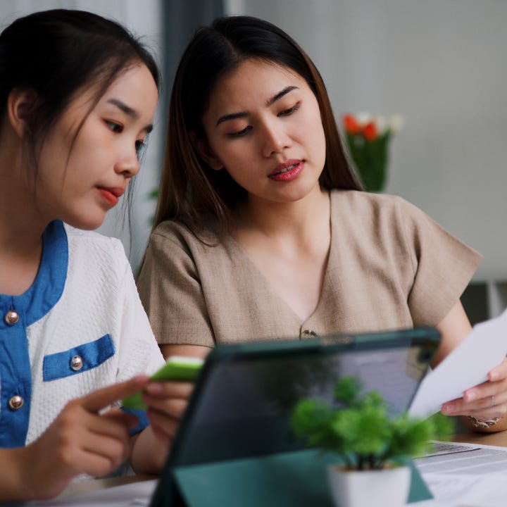 Two women reviewing documents at a table