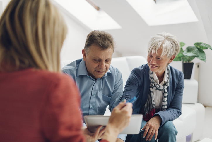 A couple reviewing their retirement plan with a financial advisor.