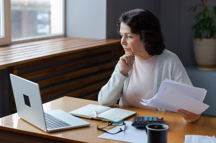 A retiree reviewing options for using RMD withdrawals, including investing, charitable giving, or building cash reserves for future needs.